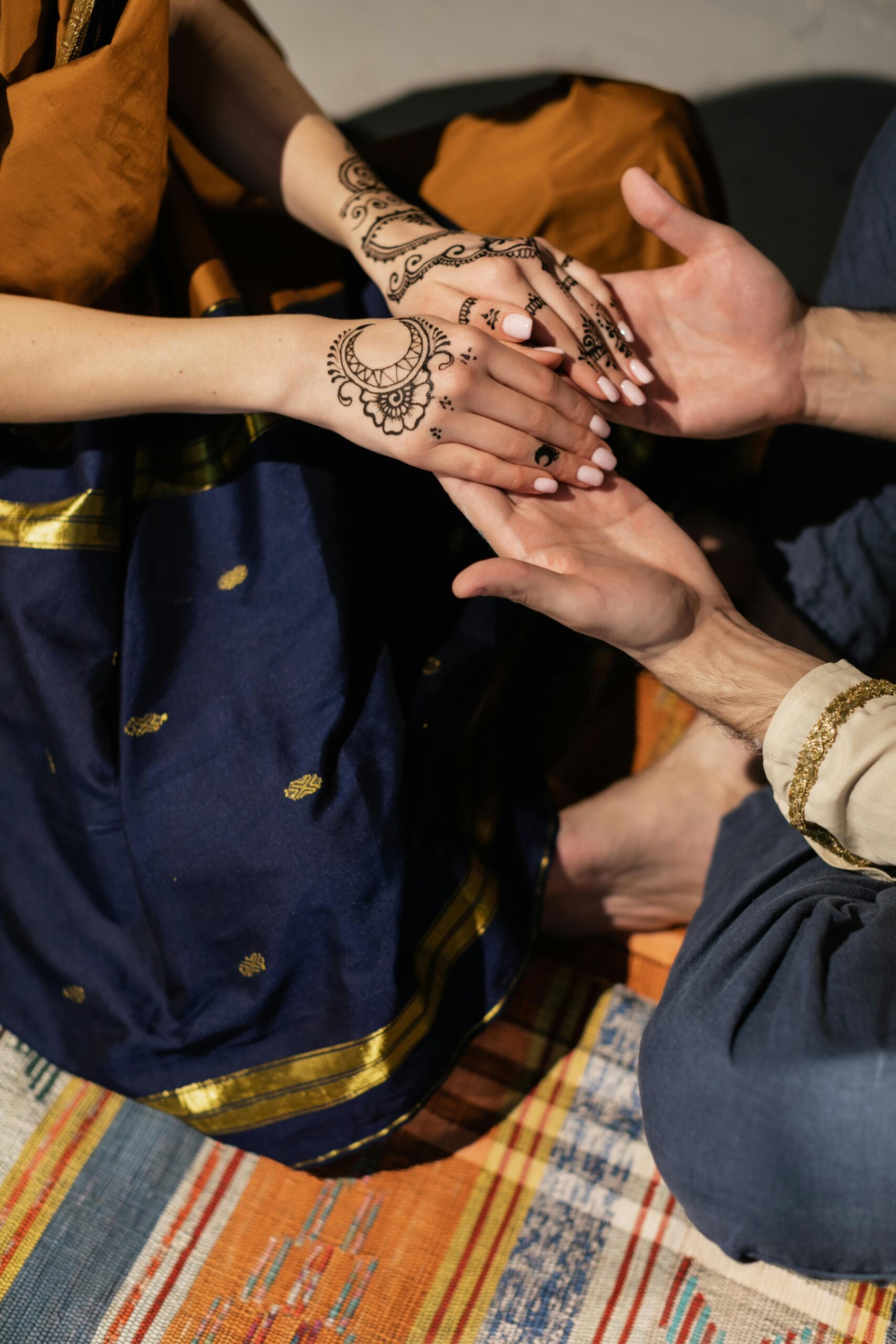 Intricate mehendi designs, showcasing traditional Indian henna art during a cultural bonding moment.